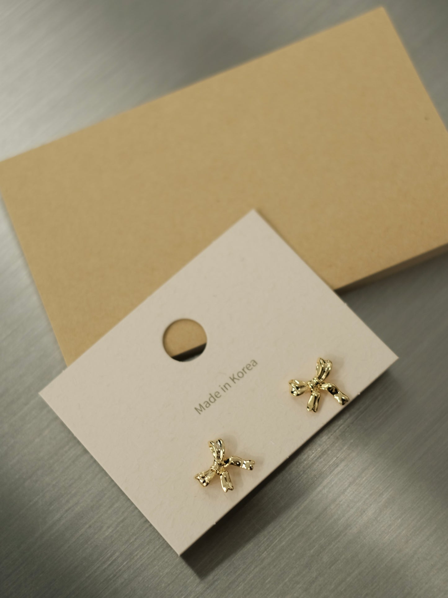 TIED RIBBON GOLD EARRINGS